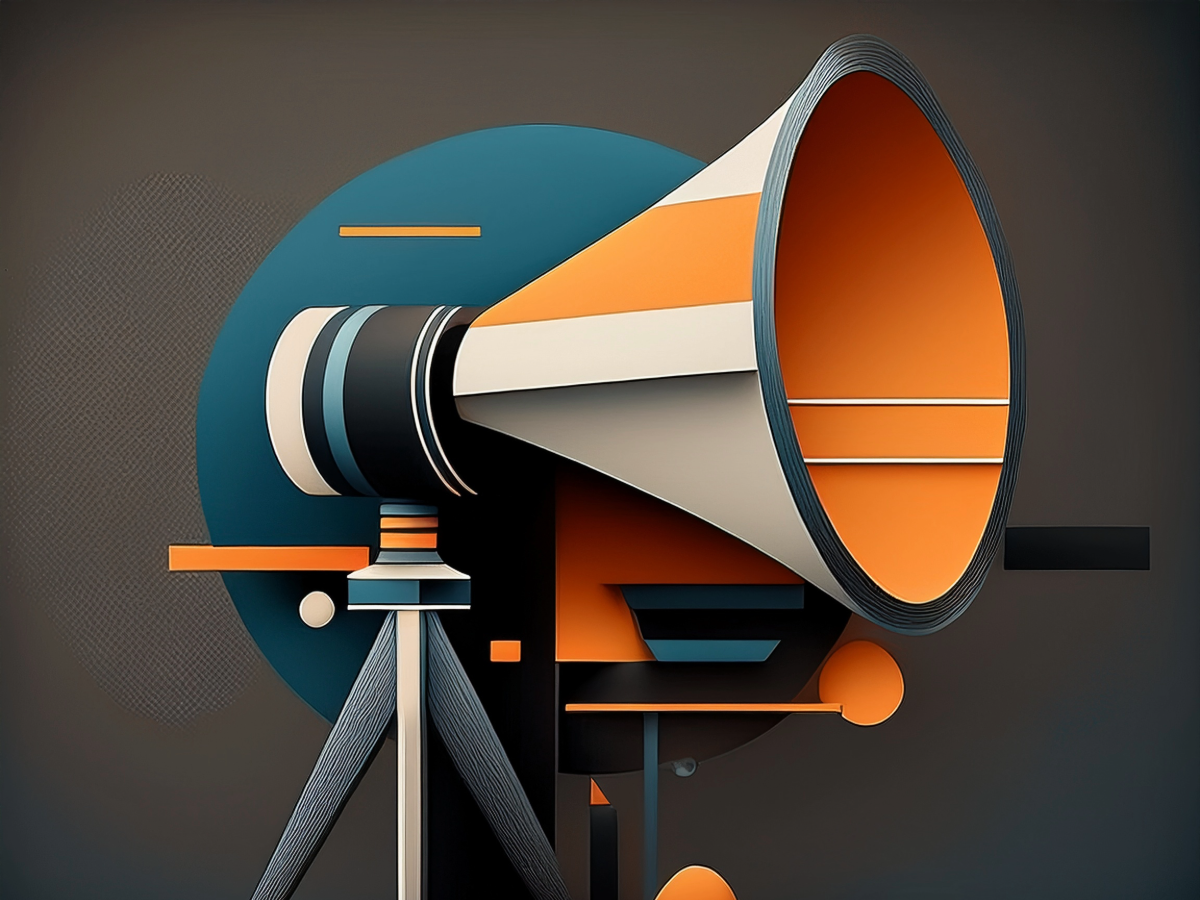Orange and turquoise megaphone against a simple gray background